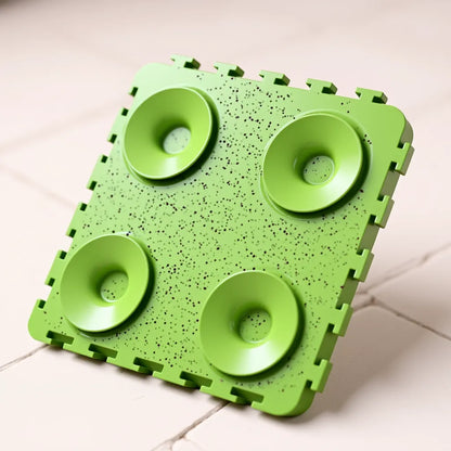 Green slow feeder tray on a tiled floor